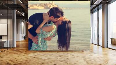 young couple kisses on the beach Wall mural