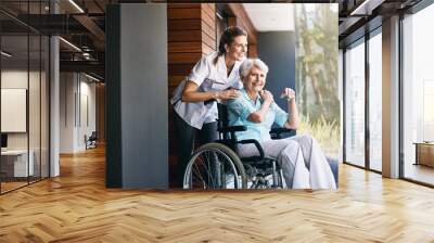 Nurse, senior woman and support on wheelchair for help or rehabilitation of medical healthcare patient. Happy caregiver, retirement and person with disability at home for recovery or care outdoor Wall mural