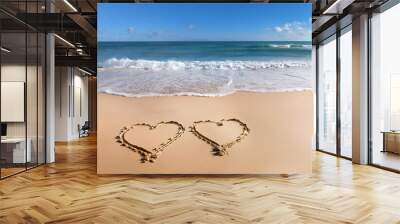 2 hearts drawn in the sand of a beautiful beach Wall mural