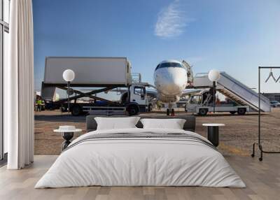 Boarding passengers on the plane. Boarding bridge. The plane lands at the international airport. Loading luggage. White airplane. Terminal Runway. Copy space Wall mural