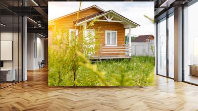 Small tiny wooden frame house with sundeck and white windows and door as a country residence in sunny summer day Wall mural