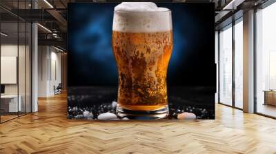 A glass of cold fresh beer with cap of foam. Splash of foam with tasty american beer. Beer day Wall mural