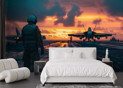 Aircraft marshaller on an aircraft carrier with fighter jet in the background at sunrise Wall mural