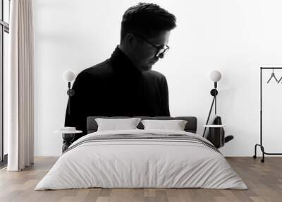 Supporting your business. Silhouette of man in glasses working on laptop Wall mural