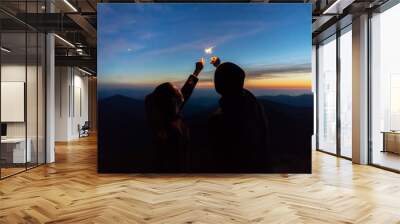 The man and a woman hold firework sticks. evening night time Wall mural