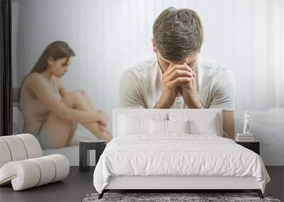 The man with impotence sit near the woman on the bed Wall mural