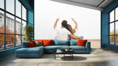 The sitting couple gesture on the background of the white wall Wall mural