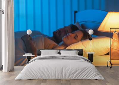 The sleeping lovers on the bed. night time Wall mural