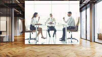 The three business people sit on the conference table Wall mural