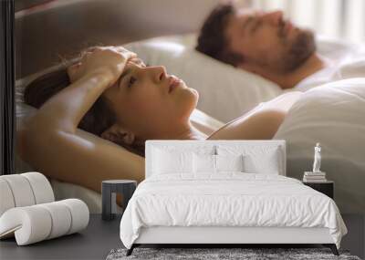 The woman with a headache lay near the man in the bed Wall mural