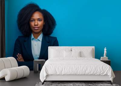 Portrait of a successful African American businesswoman wearing a blue suit on a light blue background Wall mural