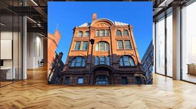 Looking up at buildings and landmarks with a clear blue sky background. Taken in Manchester England.  Wall mural