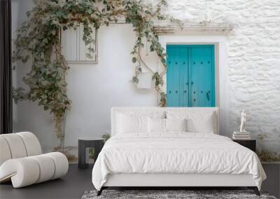 White stone house with turquoise blue wooden door, ivy climbing on the wall, rustic Mediterranean style architecture, white walls gleaming in sunlight.  Wall mural