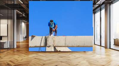 welder worker welding metal. Bright electric arc and sparks Wall mural