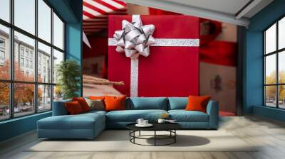 Beautiful red wrapped gift box under a modern Christmas decoration tree home. Wall mural