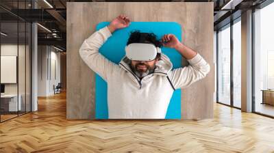 Top view of tired caucasian fitness man resting after make exercise with a VR Wall mural