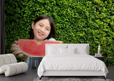 Smiling girl having enjoy eating watermelon in summer Wall mural