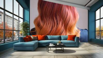 Woman with bright color dyed long curly hair Wall mural