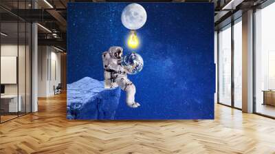 astronaut witch planet Earth under moonlight,elements of this image furnished by NASA Wall mural