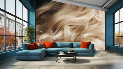 A close-up image showcasing the texture and flow of luxurious blond wavy hair with a dark background. Wall mural