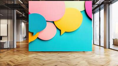 Vibrant speech bubbles in various colors create a playful backdrop, symbolizing communication and interaction in a modern context Wall mural