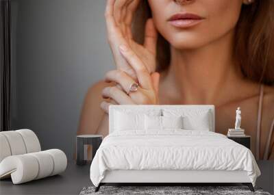 cropped view of young woman with natural lips in ring isolated on grey Wall mural