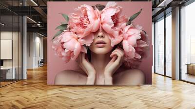 The woman is holding pink flowers in front of her face Wall mural