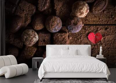 chocolate candy in cocoa on a wooden table and two hearts Wall mural