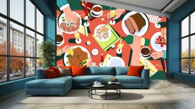 Christmas festive dinner with hands of people, decorated table top view. Delicious traditional holiday dishes on plates. Flat family celebrating thanksgiving day and eating delicious food together. Wall mural