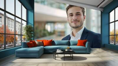 a young smiling successful businessman with bright colors and a business environment on the background of the office
 Wall mural