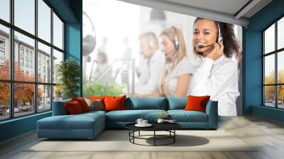 Call center worker accompanied by her team. Wall mural