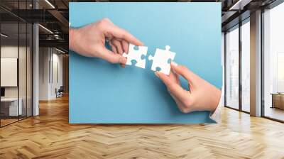 People holds in hand a jigsaw puzzle. Business solutions, success and strategy. Wall mural