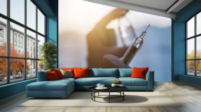 Syringe, medical injection in hand. Vaccination equipment. Wall mural