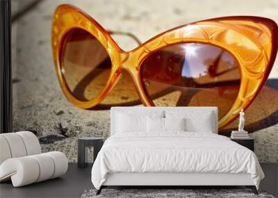 Stylish Retro Cat-Eye Sunglasses on a Sunlit Surface Wall mural