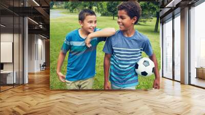 Children, boys and walking in field with soccer ball in park for happiness, development or bonding together. Friends, nature and diverse kids with smile for fun, morning or adventure on weekend Wall mural