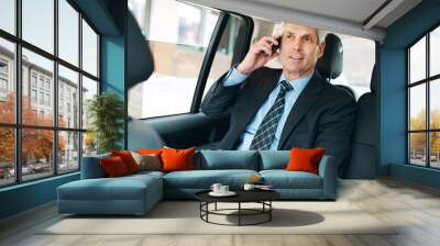 Conversation, mature man and phone call in taxi for transport, schedule meeting, communication in backseat. Mobile, vehicle and employee with paperwork for talking, commute or travel on business trip Wall mural