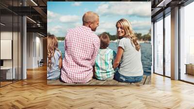 Family, lake and portrait on vacation dock, peace and travel to relax by water together. Parents, children and love on holiday by river or care in nature, bonding and outdoor for relationship on pier Wall mural