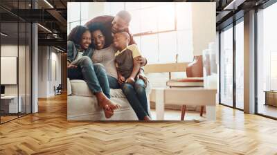 Happy, portrait and black family on sofa in home for hugging, love and care on fathers day for celebration. Smile, bonding and African kids with mom and day relaxing together in living room at house. Wall mural