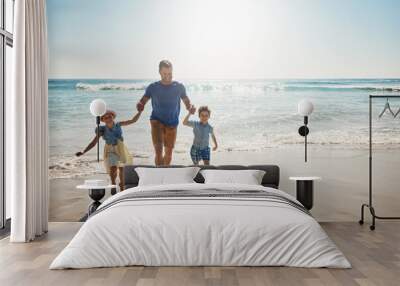 Running, holding hands and father with children at beach on holiday, vacation and tropical adventure. Family, travel and happy kids with dad by ocean for bonding, playing in waves and fun on weekend Wall mural