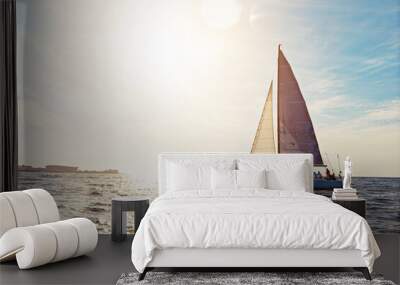 Mockup, sunset and a yacht at sea for travel, tourism or a luxury summer vacation outdoor. Blue sky, water and wave with a boat on the ocean in nature for an adventure, holiday or getaway with flare Wall mural