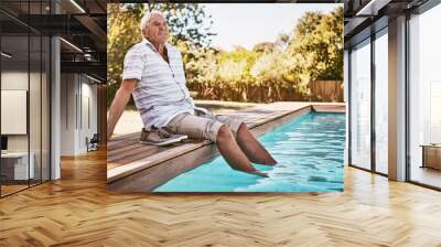 Relax, retirement and thinking with old man by swimming pool and for summer, peace and happy. Smile, calm and vacation with senior citizen with feet in water on break for happiness, holiday and fun Wall mural