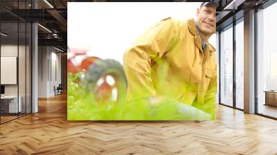 Man, farming, outdoor and portrait with tractor in field for food production with sustainability in countryside. Person, farmer and small business owner with vehicle, smile and agriculture in Spain Wall mural