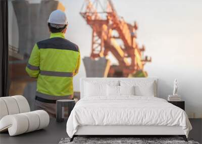 An Asian male engineer works at a motorway bridge construction site,Civil worker inspecting work on crossing construction,Supervisor working at high-speed railway construction site Wall mural