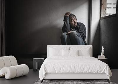 Asian man addict drug in the deserted place,A junkie feels alone in this world,Sad young man sitting in the corner of the room,People are stressed and have depression Wall mural