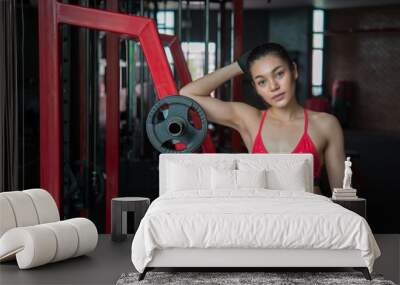 Close up asian beautiful sport girl on wall of gym,Thailand love health,Slim woman workout concept Wall mural