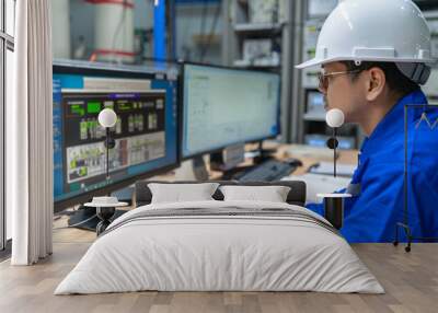 Engineer working at control room,Manager control system,Technician man monitoring program from a lot of monitor Wall mural