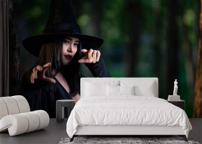 Portrait of beautiful asian sexy woman wear black witch costume with broom,Halloween festival concept Wall mural