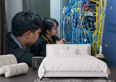 Two asian engineers working in the server room,Check the connection problems of computer networks,Thailand people Wall mural