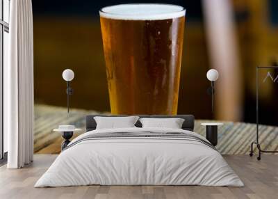 glass of beer on wooden table Wall mural