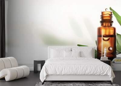 Amber Glass Bottle of Essential Oil with Green Leaves and Droplets Wall mural